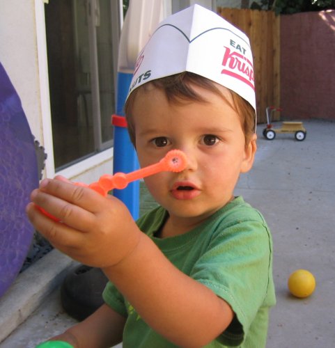 Sean with his fire hat blowing bubbus