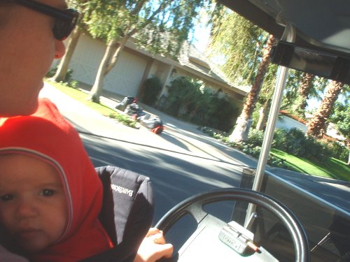 Molli and Sean driving the golf cart