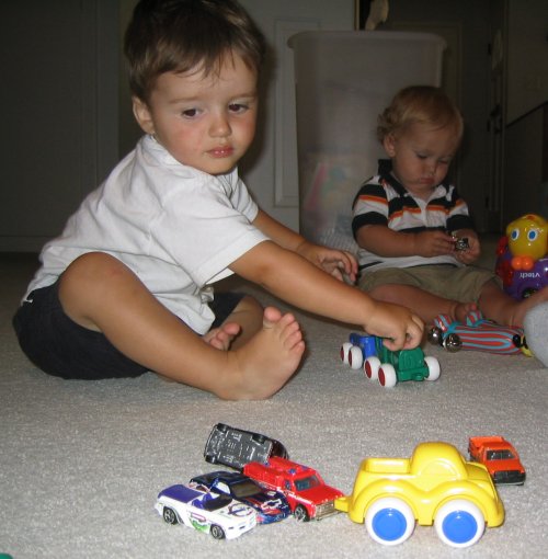 Sean and Jackson play with cars